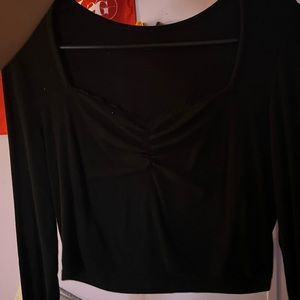 Black cropped long sleeve shirt .